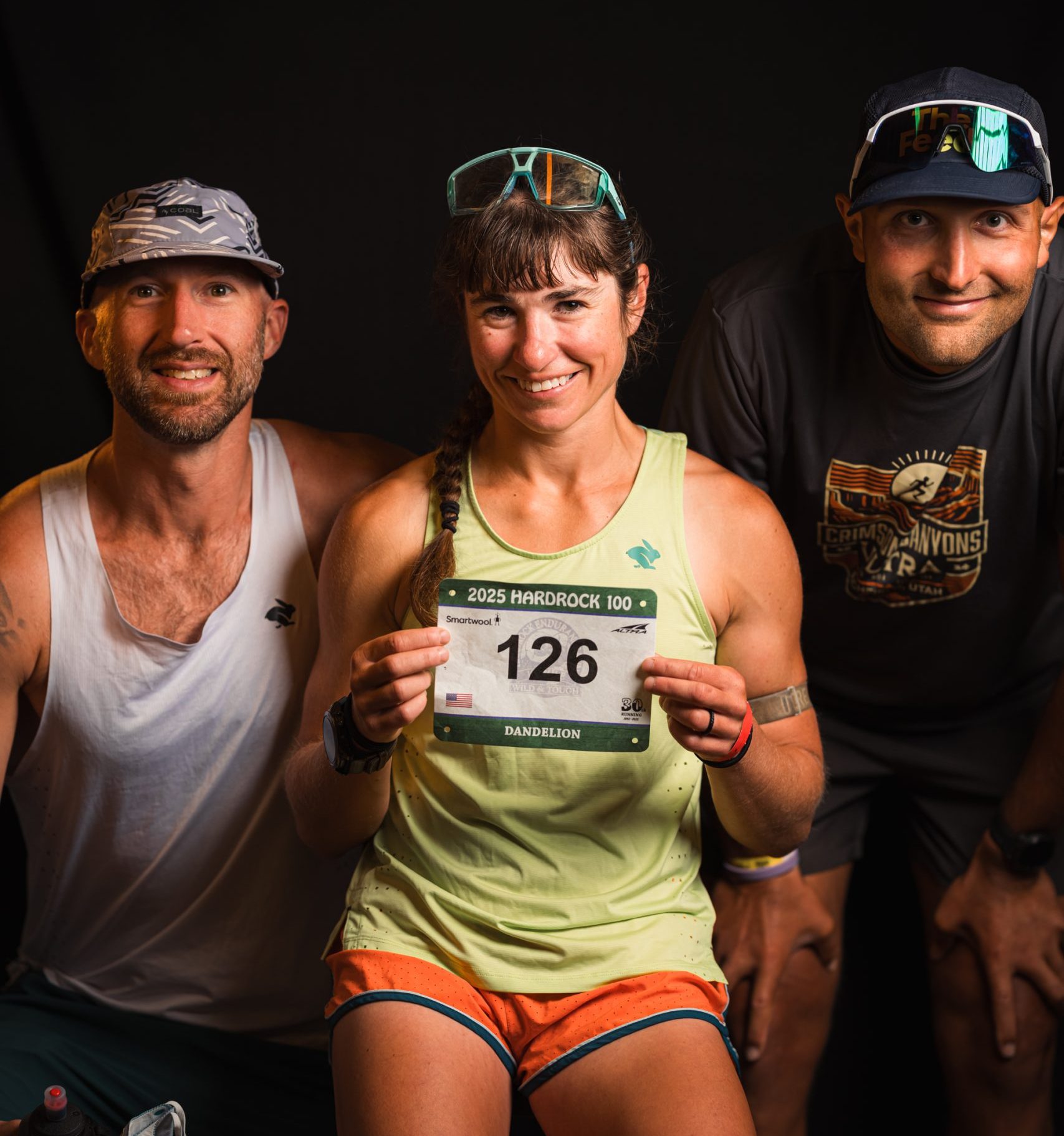 Dandelion pre-race holding her Hardrock 100 bib with her crew. PC: Travis McWhorter