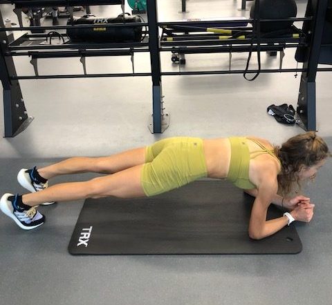 A runner performing a plank as part of a core workout.