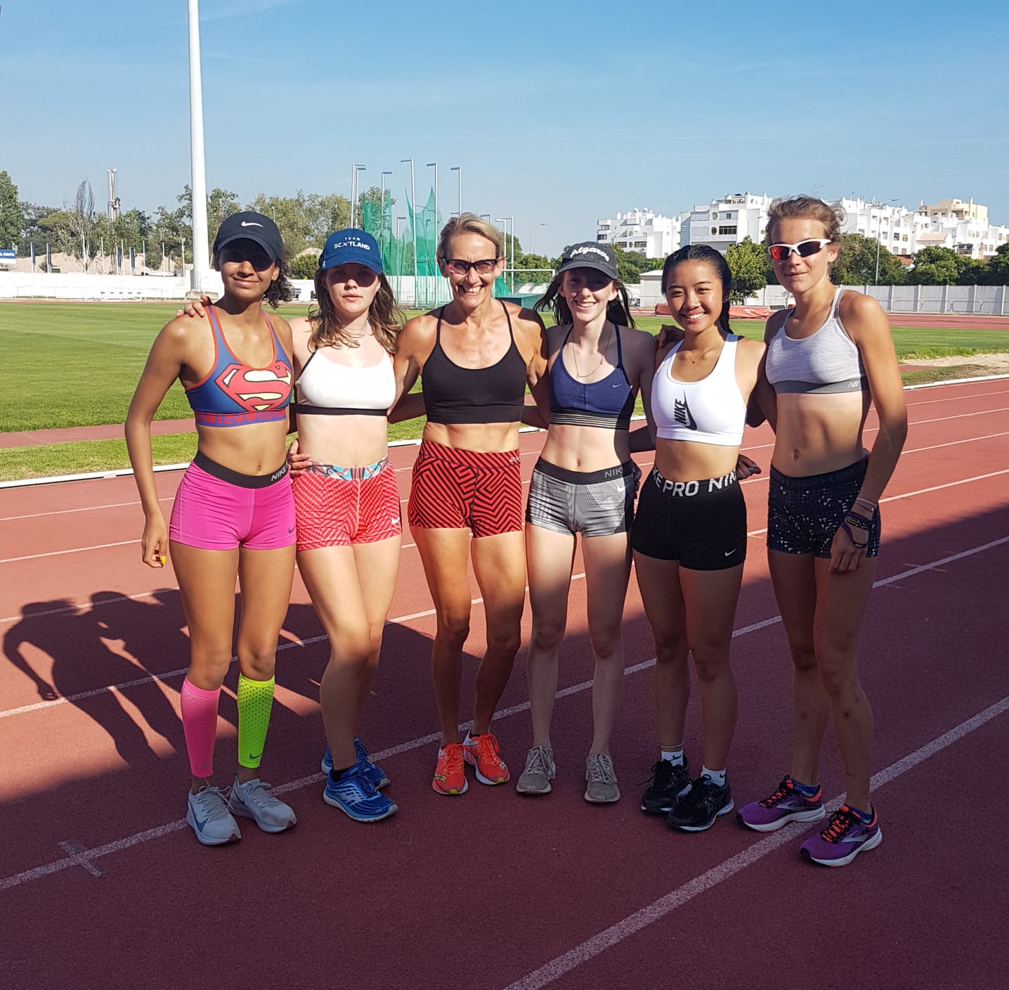 A group of female runners at the track. 