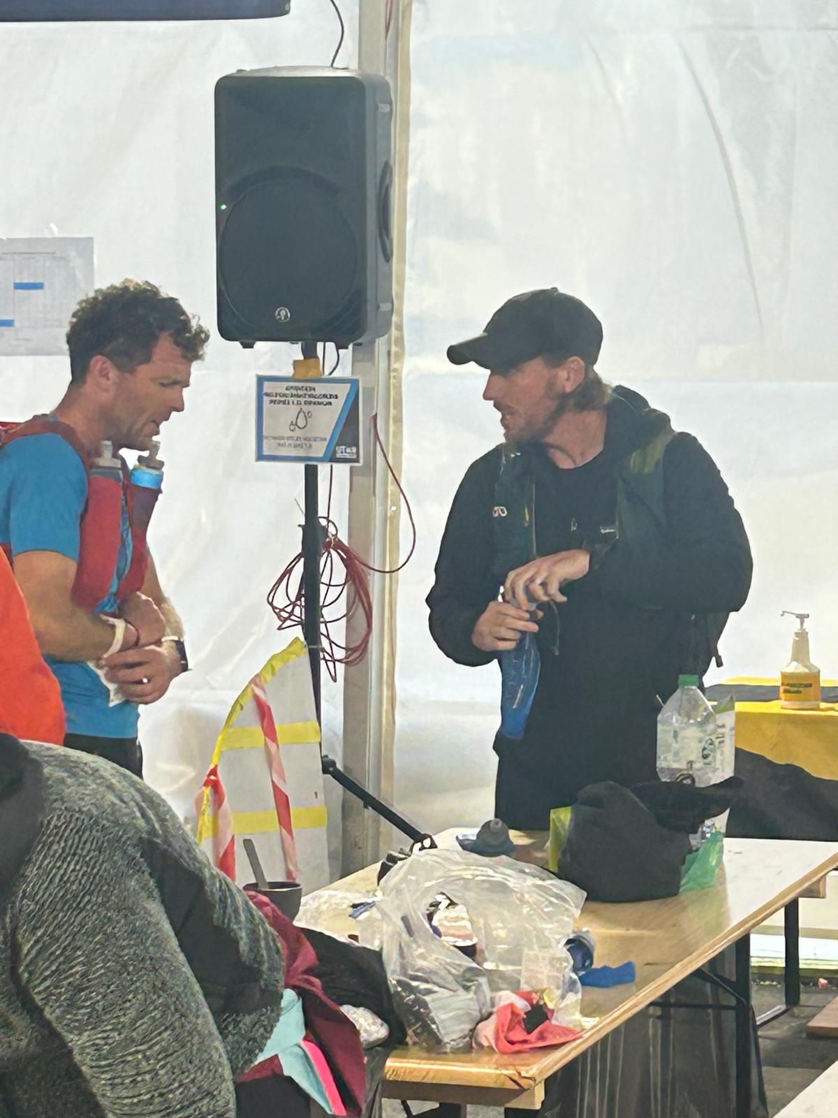 Matt meeting his crew at an aid station to refuel during UTMB.